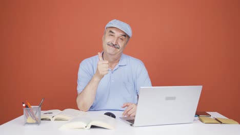Old-man-looking-at-laptop-making-positive-gesture.